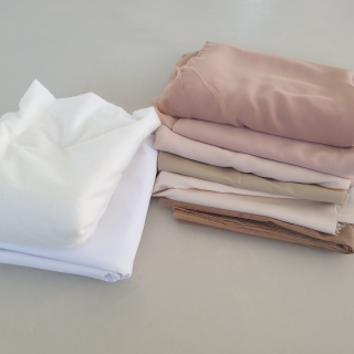 Large pieces of nude fabrics and interlinings.