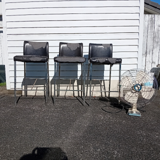 3 used bar chairs and a electric fan.