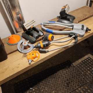 Many garden/grass lawn watering items and hoses